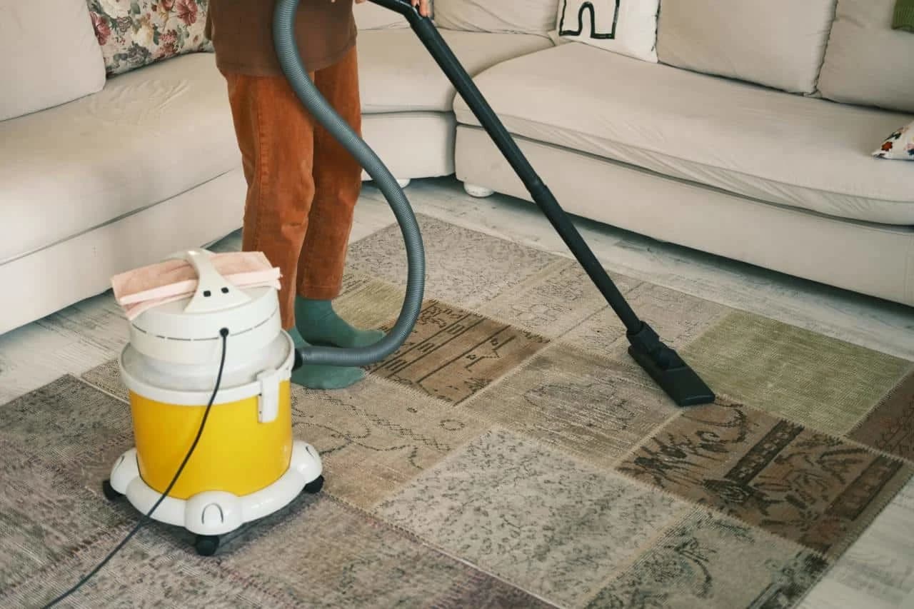 Carpet being vacuumed as part of regular maintenance